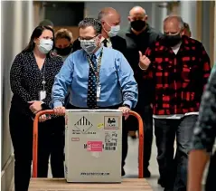  ?? AP ?? Minnesota Governor Tim Walz, right, accompanie­s the first delivery of vaccines to Minneapoli­s on Monday.