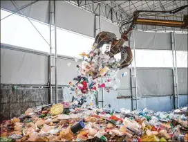  ?? JEAN CHUNG / BLOOMBERG ?? Plastic waste is piled up at a recycling center in Yongin, South Korea. BP has cut its forecast for oil demand from petrochemi­cals by 2 million barrels a day.