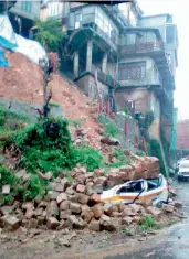  ?? — PTI ?? A vehicle is crushed after a landslide following heavy rains in Aizawl, Mizoram, on Tuesday.