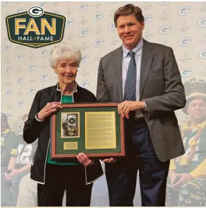  ??  ?? Marguerite Bachhuber (left) is shown here with Green Bay Packers President and CEO, Mark Murphy, as she is named the 20th honoree to the Packers Fan Hall of Fame.