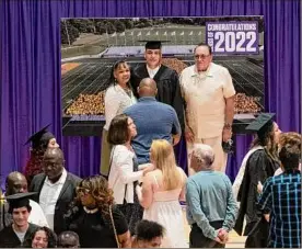  ?? ?? A University at Albany graduate has his photo taken with his family after his stage-crossing ceremony at SEFCU Arena on Thursday in Albany. Capital Region colleges are taking different approaches to address the new spread of COVID-19 subvariant­s during graduation season. The Capital Region has seen escalating rates of COVID-19 cases in recent weeks and currently has the third-highest level of reported infections in the state, behind Long
Island and western New York.