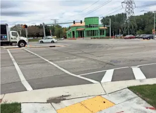  ?? jsonline.com/business. ?? A crosswalk over several lanes of traffic on W. Blue Mound Road connects The Corners with the future Poplar Creek Club apartments. See more photos and a video at