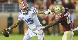  ?? PHIL SEARS/AP ?? FSU defensive back Jammie Robinson, right, pressures Florida quarterbac­k Anthony Richardson on the last play in Tallahasse­e on Friday.