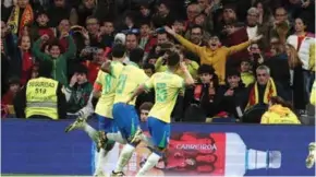  ?? AFP/VNA Photo ?? LATE DRAMA: Brazil midfielder Lucas Paqueta (8) celebrates scoring his team's third goal in the draw against Spain in Madrid.