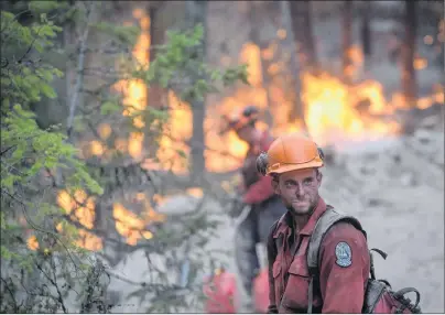  ?? CP PHOTO ?? A B.C. Wildfire Service firefighte­r looks on while conducting a controlled burn to help prevent the Finlay Creek wildfire from spreading near Peachland, B.C., on Thursday, Sept. 7.