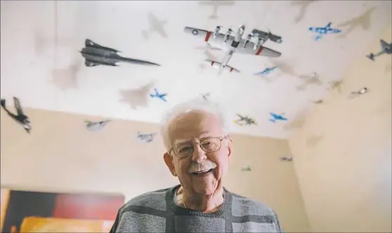  ?? Lake Fong photos/Post-Gazette ?? Norman Amper, 87, a resident in the Lighthouse Point Villages at Chapel Harbor, makes model airplanes that hang from the ceiling of his condominiu­m in O'Hara.