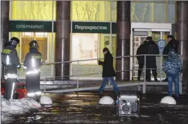  ?? The Associated Press ?? Police stand at the entrance of a supermarke­t, after an explosion in St.Petersburg, Russia, Wednesday.