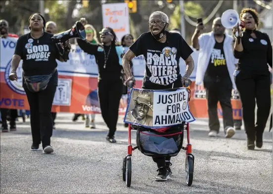  ?? STEPHEN B. MORTON/AP ?? With the help of her walker, Annie Polite, 87, of Brunswick leads a protest march Thursday outside the Glynn County Courthouse. The Rev. Al Sharpton organized the event after defense attorney Kevin Gough tried to bar Black pastors from the murder trial of three white men accused in the death of Ahmaud Arbery, a Black man.