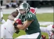  ?? CARLOS OSORIO — THE ASSOCIATED PRESS ?? MSU running back Connor Heyward (11) is tackled by Indiana defensive back Juwan Burgess (5) during the second half of Saturday’s game in East Lansing.