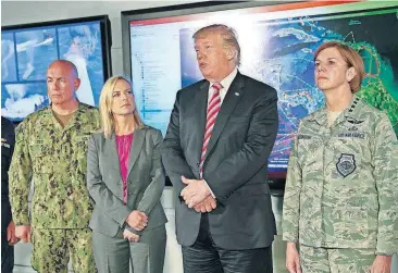  ?? [PABLO MARTINEZ MONSIVAIS/THE ASSOCIATED PRESS] ?? President Donald Trump, center, speaks to members of the media Thursday during his visit to Joint Interagenc­y Task Force South anti-smuggling center in Key West, Fla.