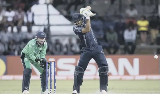  ??  ?? 2 Safyaan Sharif hits out during Scotland’s defeat by Ireland on Sunday in Harare. The Scots must now beat West Indies tomorrow to reach next summer’s World Cup.