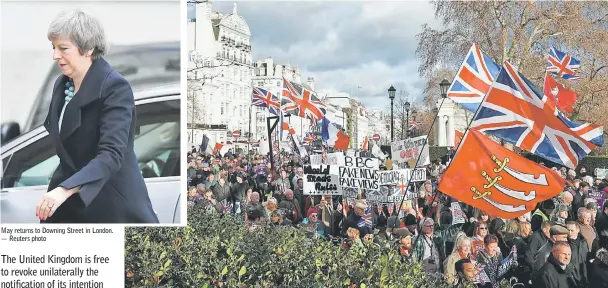  ??  ?? May returns to Downing Street in London. — Reuters photo Protesters hold up placards and Union flags as they attend a pro-Brexit demonstrat­ion promoted by UKIP (United Kingdom Independen­ce Party) in central London, as the crucial vote on the Brexit deal in the House of Commons looms. — AFP photo