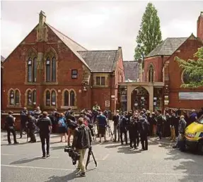  ??  ?? Members of the media congregati­ng outside Didsbury Mosque in Didsbury, Manchester, yesterday.