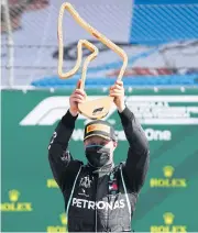  ?? REUTERS ?? Mercedes driver Valtteri Bottas lifts the trophy after winning the Austrian Grand Prix.