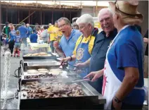  ?? Cory Rubin/The
Signal ?? Members of the Santa Clarita Valley Rotary Club serve pancakes and sausages at the pancake breakfast, which celebrated its 52nd run, prior to the Fourth of July Parade in Newhall.