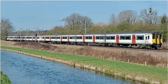  ?? David Palmer ?? Less than 20 Class 317s were in active service in March. One of the fortunate few was No. 317884, seen with a sister unit running parallel with the New River, approachin­g Ware station with a Hertford East-London Liverpool Street service on March 15.