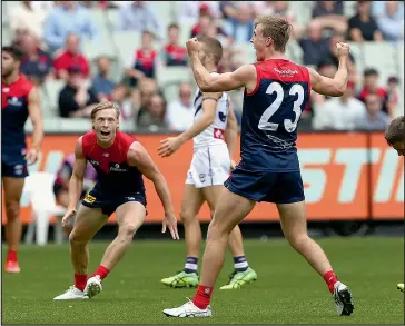  ??  ?? James Jordon who wears the number 23 for Melbourne has also played 23 senior games for his club. He is pictured here celebratin­g a goal in his stunning AFL debut back in March during Melbourne’s first round match against Fremantle at the MCG. Albury recruit and teammate Charlie Spargo looks is pictured looking on. Photo: AAP.