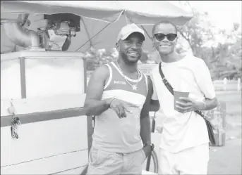  ?? ?? Letitia Wright takes a snap with a sno-cone vendor as she holds on to that ice cold sno-cone in a red cup. (Ministry of Tourism, Industry and Commerce photo)