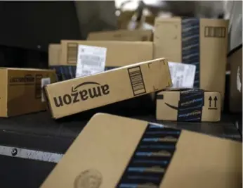  ?? PATRICK SEMANSKY/THE ASSOCIATED PRESS FILE PHOTO ?? Firms such as Amazon are “blurring sector boundaries as they seek to be all things to all people,” the report said.