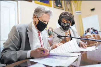  ?? J. Scott Applewhite The Associated Press ?? Washington lawmakers Frank Pallone, D-N.J., left, and Maxine Waters, D-Calif., prepare an emergency extension of the eviction moratorium Friday at the Capitol.