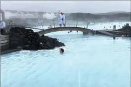  ??  ?? Top: The view looking out from the Black Diamond ice cave in Skaftafell, a wilderness area in Vatnajokul­l National Park.
Above: One of the most popular attraction­s in Iceland, the Blue Lagoon is a geothermal spa where visitors can swim and spread...