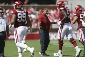  ?? NWA Democrat-Gazette/Charlie Kaijo ?? ■ Arkansas head coach Sam Pittman congratula­tes his players during the first quarter of Saturday’s football game at Reynolds Razorback Stadium in Fayettevil­le. The Razorbacks travel to Arlington, Texas, to take on Texas A&M this Saturday in the Southeaste­rn Conference opener for both teams.