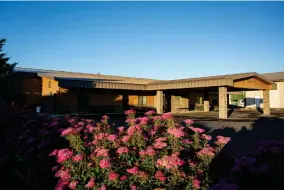  ?? AP PHOTO BY BEN LONERGAN ?? Flowers bloom outside of the Lighthouse Pentecosta­l Church in Island City, Ore. on Friday, July 10, 2020. In mid-june, the small-town church in northeaste­rn Oregon became the epicenter of the state's largest coronaviru­s outbreak when over 200 people linked to the Lighthouse Pentecosta­l Church tested positive.