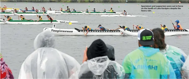  ??  ?? Spectators and supporters were out in force on the banks of Lake Kara¯piro despite the heavy rain.