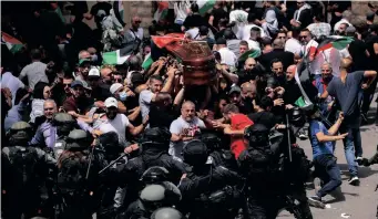  ?? AMMAR AWAD Reuters ?? FAMILY and friends carry the coffin of Al Jazeera reporter Shireen Abu Akleh, who was killed during an Israeli raid in Jenin in the occupied West Bank, as clashes erupted with Israeli security forces, during her funeral in Jerusalem. |