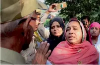  ??  ?? Missing JNU student Najeeb’s mother argues with the police during a rally in New Delhi on Friday. —PTI