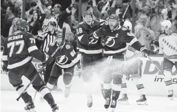  ?? CHRIS O'MEARA AP ?? Tampa Bay captain Steven Stamkos, right, celebratin­g one of his two goals in the series-clinching win against the Rangers, says the Lightning is successful because ‘we trust every guy that goes over that boards to do his job.’