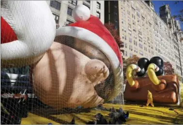  ?? SETH WENIG—THE ASSOCIATED PRESS ?? Balloons are held down by nets while being inflated for the Macy’s Thanksgivi­ng Day Parade in New York, Wednesday.