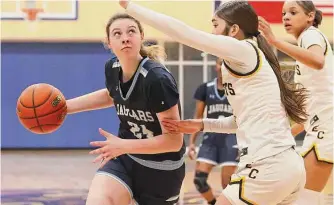  ?? Kin Man Hui/staff photograph­er ?? Johnson’s Addison Iden, left, drives to the basket against East Central’s Devyn Castillo on Tuesday at Alamo Heights High School. Iden scored 14 points in the Jaguars’ first-round win.