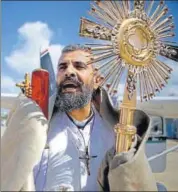  ??  ?? Lebanese Christian Maronite priest Majdi Allawi holds the Blessed Sacrament near the capital Beirut to protect the country from disease amid fears of the spread of the novel coronaviru­s.
AFP