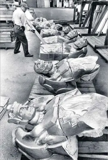  ?? John Malmin Los Angeles Times ?? WRECKERS removed 40 gilded terra cotta sculptures that resembled Roman soldiers with angel’s wings from the Richfield Building, a downtown L.A. landmark that was torn down in 1969. A few have survived.