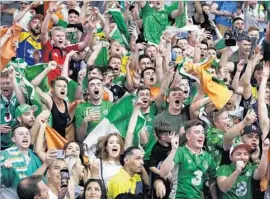  ?? John Locher Associated Press ?? CONOR McGREGOR FANS, many from Ireland, cheer after the weigh-in for McGregor and Floyd Mayweather Jr. on Friday in Las Vegas.