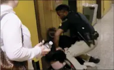  ??  ?? In this Jan. 8 file image made from a video provided by KATC-TV, middle-school English teacher Deyshia Hargrave is handcuffed by a city marshal after complying with a marshal’s orders to leave a Vermilion Parish School Board meeting in Abbeville, La.,...