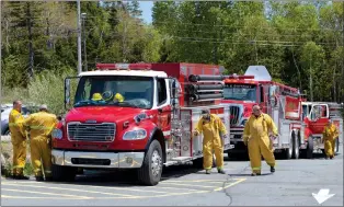  ?? CANADIAN PRESS PHOTO ?? Firefighte­rs arrive at a command centre within the evacuated zone while taking a break from battling the wildfire burning in Tantallon, N.S. outside of Halifax last week.