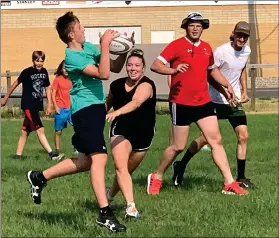  ?? HERALD PHOTO BY DALE WOODARD ?? Shay Milroy hauls in a pass as Jamie Dolyniuk closes in at the Come Try It rugby clinic Friday afternoon at the Lethbridge Rugby Club. The one-day clinic was hosted by University of Lethbridge Pronghorns rugby players Savanna Collison and Keegan Brantner, who are also Youth Developmen­t Coordinato­rs for the Junior Rugby Alberta Associatio­n.