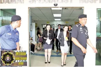  ??  ?? Cindy (centre) walking out of the Damai Specialist Hospital after issuing the release order.