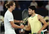  ?? MARTIN KEEP/AFP/ GETTY IMAGES ?? Alexander Zverev (L) greets second-seeded Carlos Alcaraz after defeating him in the Australian Open quarterfin­als.