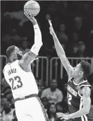  ?? Curtis Compton / TNS ?? LeBron James led the Lakers with 32 points against the Hawks despite a busy weekend of traveling to see his son Bronny’s game and play in two of his own.