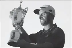  ?? Associated Press photo ?? Dustin Johnson holds the trophy after winning the U.S. Open golf championsh­ip at Oakmont Country Club on Sunday in Oakmont, Pa.