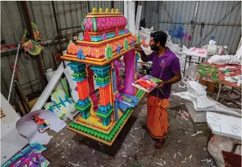  ?? — Bernama photo ?? Lawrence works on a kavadi ordered by a customer for the upcoming Thaipusam celebratio­n.