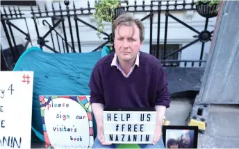  ?? AFP file photo ?? Ratcliffe sits during his hunger strike outside the Iranian embassy in solidarity with his wife and protesting to call for her release in London on June 17, 2019. —