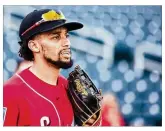  ?? ROB TRINGALI / GETTY IMAGES ?? Billy Hamilton sprained a finger trying to catch a line drive off the bat of teammate Jose Peraza during batting practice.