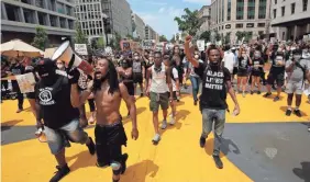  ??  ?? Demonstrat­ors protest near the White House in Washington, D.C., on Saturday. A section of the street was renamed “Black Lives Matter Plaza,” and that rallying cry was painted on the road in bright yellow letters.