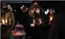  ??  ?? People attend a vigil for the Boulder shooting victims in Colorado on 24 March. Photograph: Alyson Mcclaran/Reuters