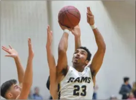  ?? THOMAS NASH - DIGITAL FIRST MEDIA ?? Methacton’s Noah Baker (23) rises over a couple Methacton defenders for a basket during the second half of Thursday’s game against Spring-Ford.