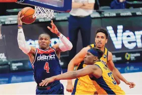  ?? ALEX BRANDON/ASSOCIATED PRESS ?? Washington Wizards guard Russell Westbrook (4) shoots past Indiana Pacers center Myles Turner (33) and guard Malcolm Brogdon during Monday’s game in Washington.